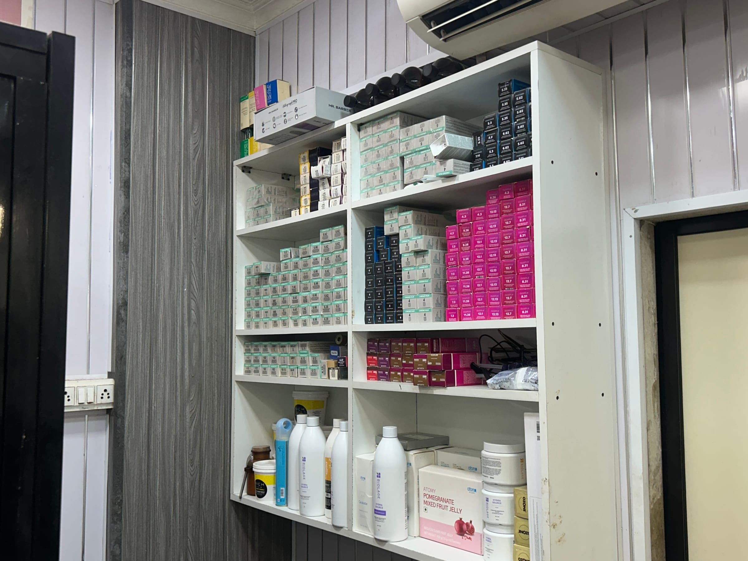 Organised shelf of professional hair colour and treatment stock