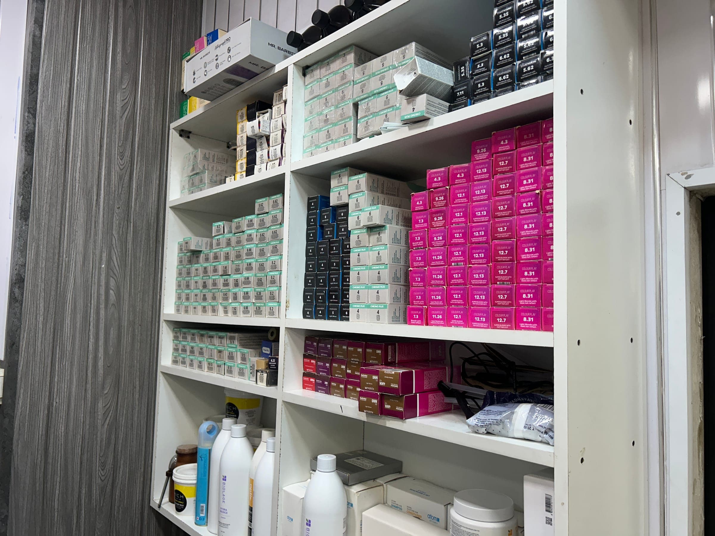 Close-up of colour-coded hair colour product inventory