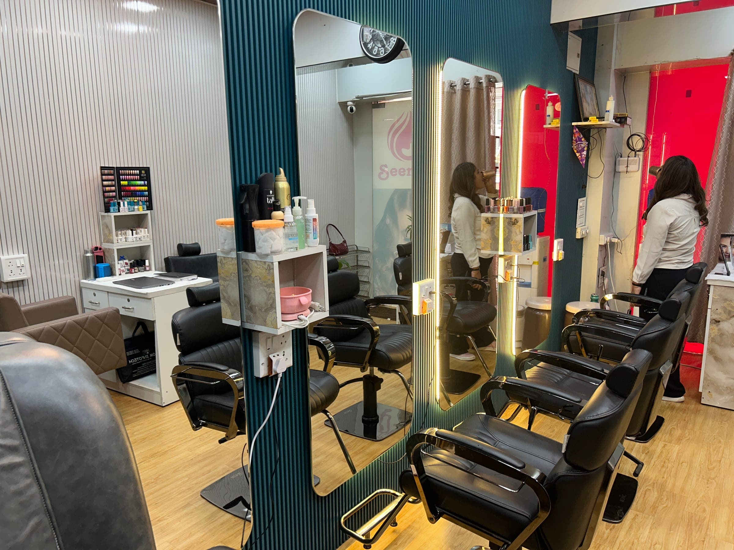 Hair styling area with backlit mirrors and styling chairs