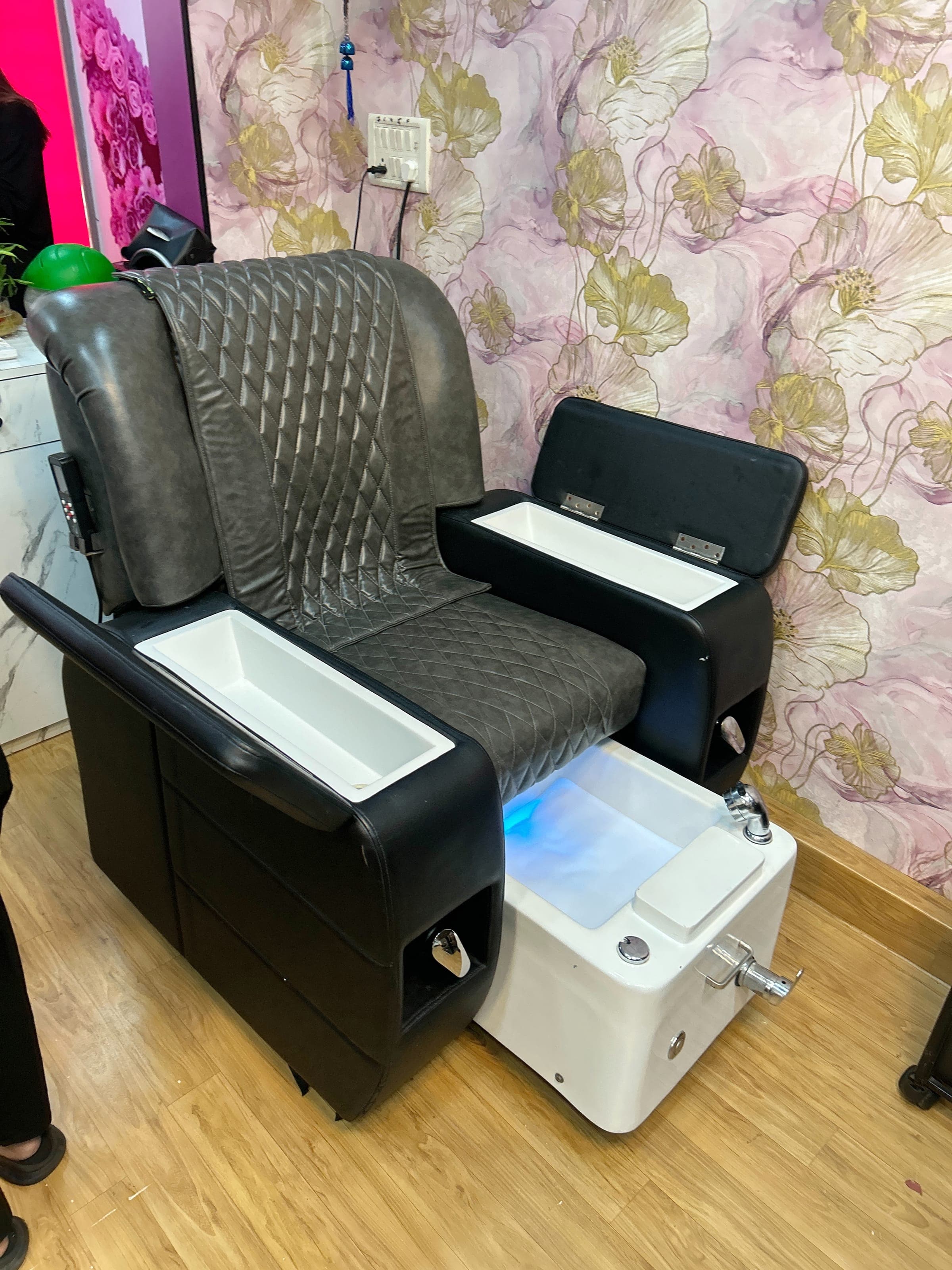 Pedicure spa chair with foot basin in a nail care treatment room