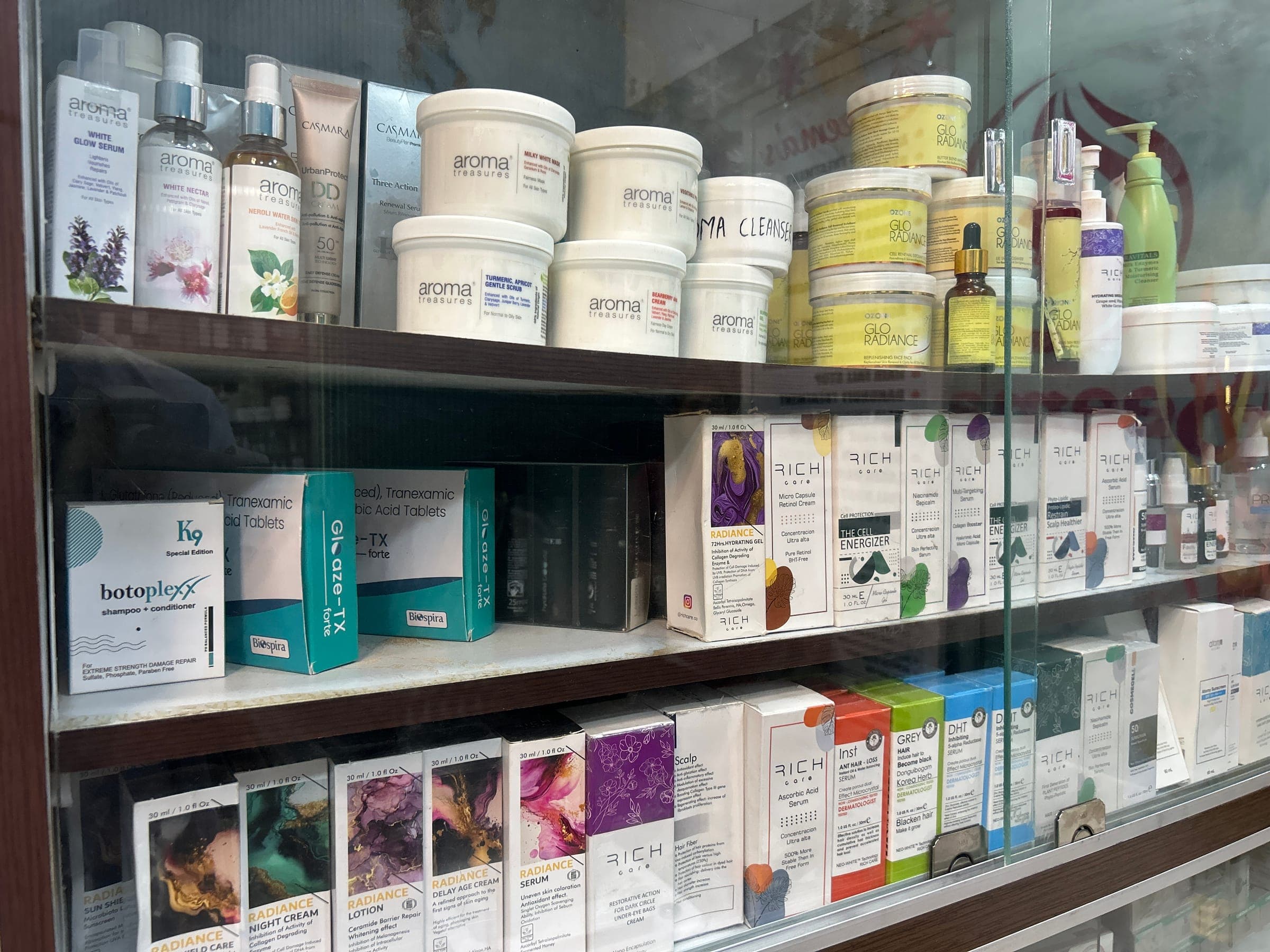 Glass-front cabinet stocked with professional skincare products