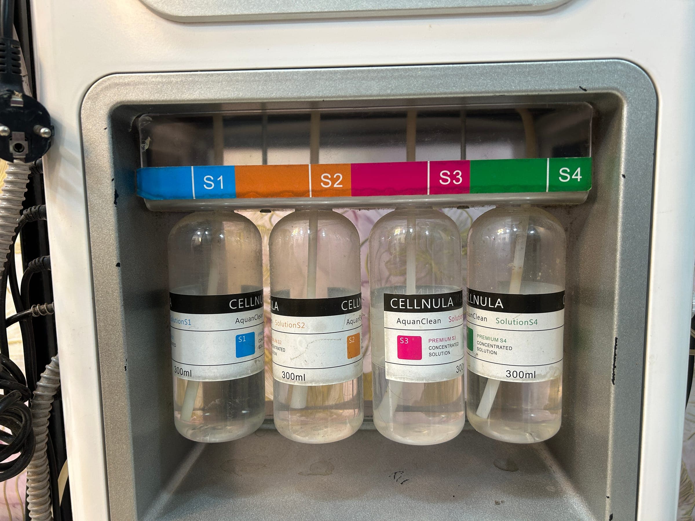 Colour-coded Cellnula AquanClean treatment solutions used during facial procedures