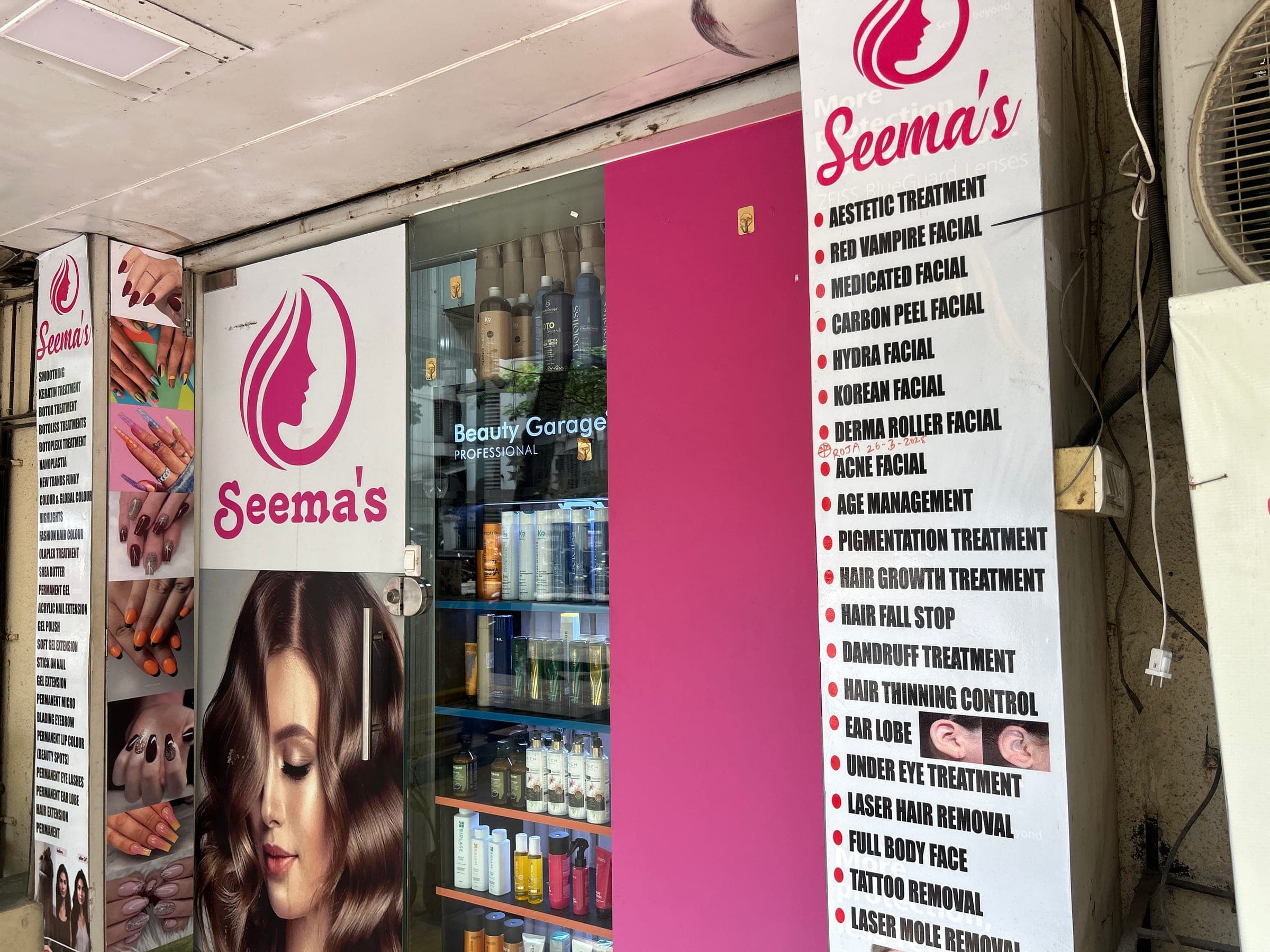 Wider view of the in-store treatment menu signage including facials and laser services